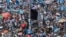 FILE - Protesters raise a black Guatemalan flag in Constitution Plaza as they demand the resignation of Guatemalan President Jimmy Morales in Guatemala City, Sept. 20, 2017. 