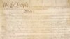 This photo made available by the US National Archives shows a portion of the first page of the United States Constitution.