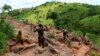 FILE - Gold miners work at an open-pit gold mine in Lukingi village in Mubende district, about 150 km (90 miles) southwest of Uganda's capital Kampala.