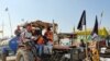 Farmers celebrate at Singhu border, one of the protest sites where farmers have been camping after Prime Minister Modi announced the decision to roll back three contentious farm laws. (VOA/Anjana Pasricha)