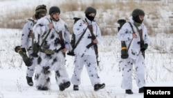 Ukrainian service members walk with M141 Bunker Defeat Munition weapons supplied by the United States during drills at the International Peacekeeping Security Centre near Yavoriv in the Lviv region, Ukraine, February 4, 2022. 