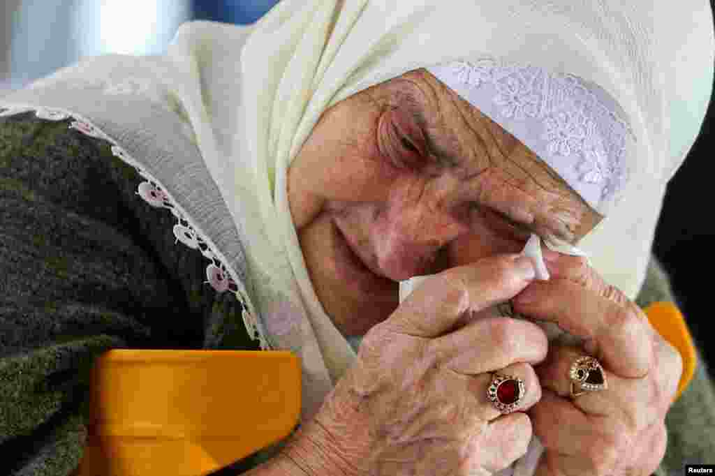 A Bosnian Muslim woman reacts as she awaits the final verdict of former Bosnian Serb military leader Ratko Mladic in the Srebrenica-Potocari Genocide Memorial Center, Bosnia and Herzegovina.