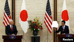 U.S. Vice President Mike Pence (L) and Japan's Deputy Prime Minister Taro Aso attend their joint news conference after their talks at the Prime Minister Shinzo Abe's official residence in Tokyo, April 18, 2017. 