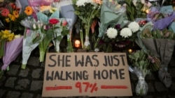 FILE - A sign is seen as people gather at a memorial site in Clapham Common Bandstand, following the kidnap and murder of Sarah Everard, in London, Britain, March 13, 2021.