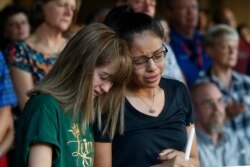 High School students Celeste Lujan, left, and Yasmin Natera mourn their friend Leila Hernandez, one of the victims of the Saturday shooting in Odessa, at a memorial service in Odessa, Texas, Sept. 1, 2019.