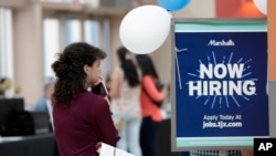FILE - Daisy Ronco waits in line to apply for a job with Marshalls during a job fair at Dolphin Mall in Miami, Oct. 1, 2019.