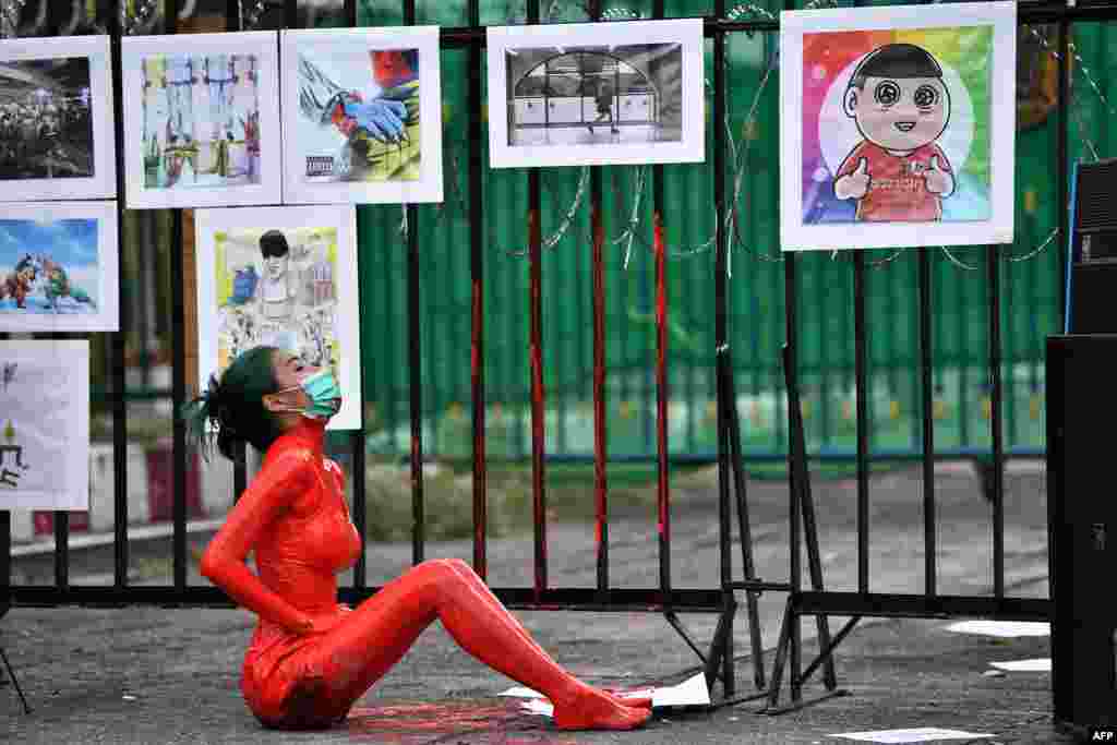 A protester is covered in red paint during a demonstration against the government of Thailand&#39;s Prime Minister Prayut Chan-O-Cha and in support of the release of political prisoners outside Bangkok Remand Prison in Bangkok.