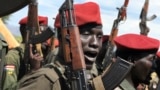 FILE - Government soldiers raise their guns during a military parade in Juba, South Sudan, on April 14, 2016. 