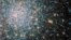 A globular star cluster called Messier 5 (M5) containing 100,000 stars or more and packed into a region around 165 light-years in diameter is seen in an undated image taken by NASA's Hubble Space telescope and released April 25, 2014. Messier 5 lies some 25,000 light-years away and its stars are estimated to be nearly 13 billion years old, according to NASA. 