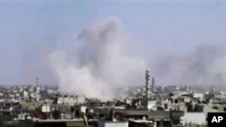 Thành phố Homs bị pháo kích (ảnh tư liệu ngày 11 tháng 4, 2012)