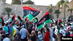 Demonstrators march during an anti-government protest in Tripoli, Libya, Aug. 25, 2020.