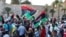 Demonstrators march during an anti-government protest in Tripoli, Libya, Aug. 25, 2020.