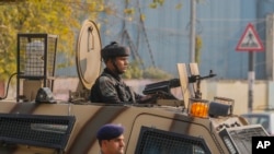 Indian paramilitary soldiers guard at the site of grenade explosion at a marketplace in Srinagar, Indian controlled Kashmir, Nov. 3, 2024.