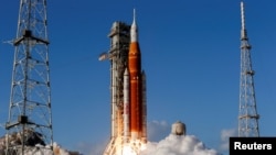 NASA's Artemis II mission to fly by the moon, comprising of the Space Launch System (SLS) rocket with the Orion crew capsule, lifts off