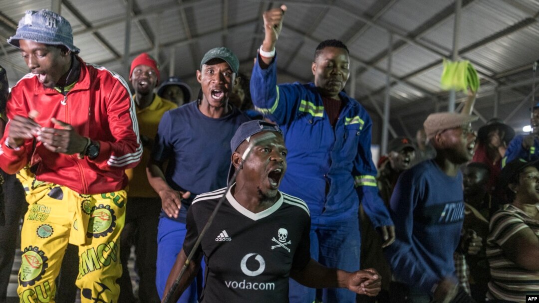 Mineworkers demonstrate outside the entrance to the Gold One Modder East operation mineshaft in Springs, on October 24, 2023. More than 500 miners in South Africa have remained underground for over 36 hours because of a standoff between rival labor unions, police and workers.