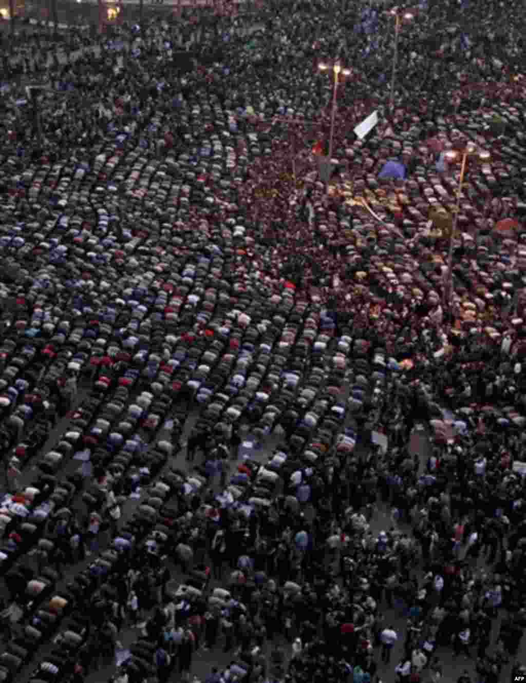 Anti-government protesters pray, as others demonstrate in Tahrir, or Liberation Square in Cairo, Egypt, Tuesday, Feb. 1, 2011. More than a quarter-million people flooded into the heart of Cairo Tuesday, filling the city's main square in by far the largest