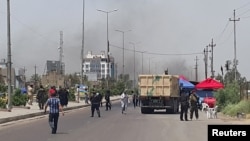 Smoke rises from a car bomb attack in the Saydiya district of southern Baghdad, May 2, 2016. 