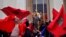 Demonstrators wave Moroccan flags during a protest in Paris, March 20, 2016. 