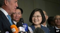 Taiwan President Tsai Ing-wen, center, listens as Michael Splinter, far left, chair of the Taiwan U.S. Chamber of Commerce, speaks to the media at the U.S. Taiwan Business Summit, July 12, 2019, in New York. 