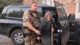In this photo provided by Ukrainian National Police of Donetsk region, Lidia Lomikovska, 98, is helped by a police officer after she escaped Russian-occupied territory, April 26, 2024. Lomikovska left her frontline town of Ocheretyne by walking almost 10 km (6 miles) alone.