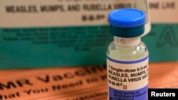A vial of measles, mumps and rubella vaccine and an information sheet is seen at Boston Children's Hospital in Boston, Feb. 26, 2015.