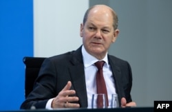 German Finance Minister and Vice-Chancellor Olaf Scholz addresses a press conference following talks via video conference with Germany's state premiers in Berlin on Dec. 13, 2020.