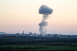 Smoke billows above the rebel-controlled village of Sarmin near the regime-held town of Saraqeb, in the eastern part of the Idlib province in northwestern Syria, on March 3, 2020, during air-strikes by pro-regime forces.