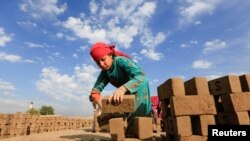 An Afghan girl works at a brick-making factory on the outskirts of Jalalabad city, eastern Afghanistan Nov. 13, 2019. 