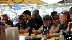 People crowd around bars in Sturgis, S.D., Aug. 7, 2020, during the 80th anniversary of the Sturgis Motorcyle Rally. 