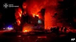 In this photo provided by the Ukrainian Emergency Service, firefighters put out the flames following a Russian rocket attack in Dobropillya, Donetsk region, Ukraine, March 8, 2025.