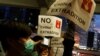 People hold placards during a protest against a proposed extradition bill, near the Legislative Council building in Hong Kong, June 13, 2019. 