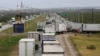 ARCHIVO - Camiones esperan en una larga fila para el control aduanero fronterizo para cruzar a EEUU en el Puente del Comercio Mundial en Nuevo Laredo, México, el 2 de noviembre de 2016. 