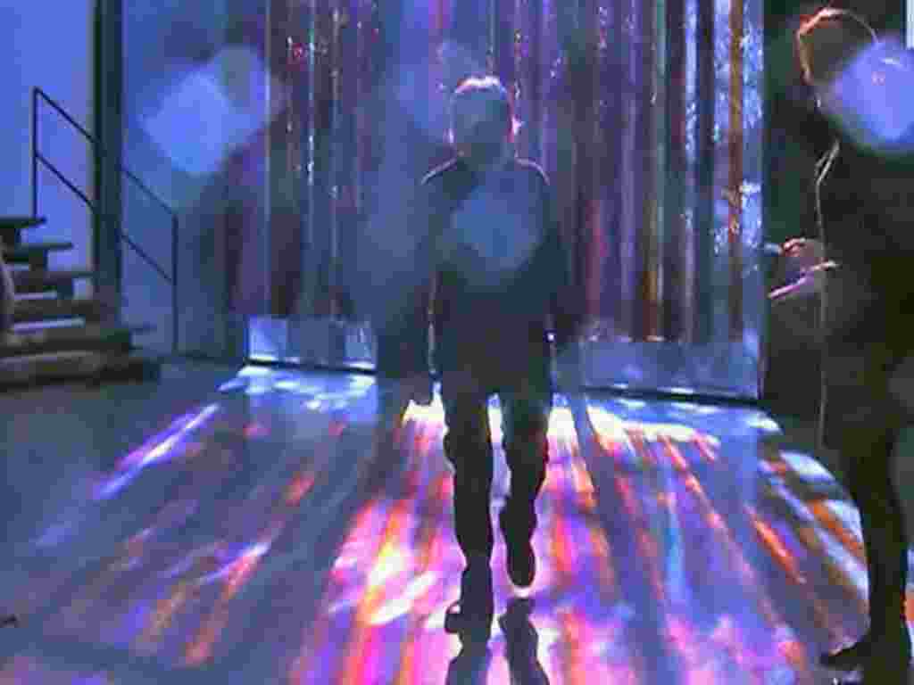 Kinetic artist Carlos Cruz-Diez walks out of his exhibit of illusion-filled pieces of color and light on display at the Museum of Fine Arts in Houston, Texas, February 2011
