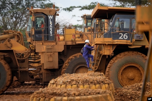 An operator climbs onto a dump truck at the beginning of a shift at PT Vale Indonesia's nickel processing plant in Sorowako, South Sulawesi, Indonesia, Tuesday, Sept. 12, 2023. (AP Photo/Dita Alangkara)