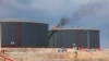 FILE - Crude oil storage tanks are seen at the Zawiya oil refinery, in Zawiya, Libya, Dec. 18, 2013.