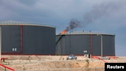 FILE - Crude oil storage tanks are seen at the Zawiya oil refinery, in Zawiya, Libya, Dec. 18, 2013.