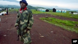 A Congolese army (FARDC) soldier stands outside the deserted town of Kibumba, May 8, 2012.