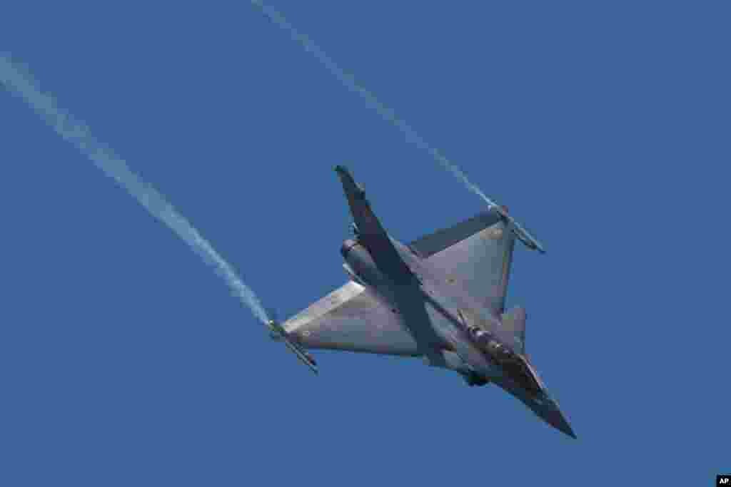 فرانس کا تیار کردہ رافیل جنگی طیارہ ایئر شو کے دوران پرواز کر رہا ہے۔