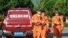 Tim SAR melakukan pencarian macan tutul yang melarikan diri dari taman safari di Hangzhou, provinsi Zhejiang timur China, 9 Mei 2021. (Foto: STR / AFP)