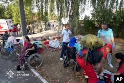 Elderly people are evacuated after a Russian strike hit a home for the elderly in Sumy, Ukraine, Sept. 19, 2024. (Ukraine's Emergency Service via AP)