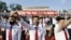 FILE - North Korean youth and students wearing protective face masks hold a rally condemning leaflets launched by defectors in South Korea with messages critical of Kim Jong Un's regime, in Pyongyang, North Korea, June 6, 2020. (Kyodo via Reuters)