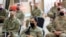 FILE - U.S. soldiers wearing protective masks are seen during a handover ceremony of Taji military base from US-led coalition troops to Iraqi security forces, in the base north of Baghdad, Iraq Aug. 23, 2020. 