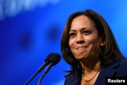 FILE PHOTO: Democratic 2020 U.S. presidential candidate and U.S. Senator Kamala Harris (D-CA) takes the stage at the New Hampshire Democratic Party state convention in Manchester, New Hampshire, Sept. 7, 2019.