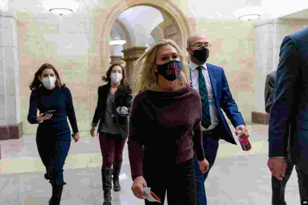 Rep. Marjorie Taylor Greene, R-Ga., walks back to her office after speaking on the floor of the House Chamber on Capitol Hill in Washington. Lawmakers will vote on whether to remove Greene, who backs the QAnon conspiracy group, from two House committees.