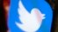 FILE - The Twitter app is seen on a mobile phone in Philadelphia, April 26, 2017. 