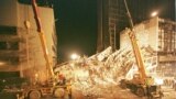 Rescuers work by floodlight at the wreckage of the destroyed Ufundi House in Nairobi, Kenya on Aug. 9, 1998, next to the American embassy building at left.