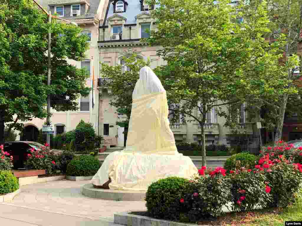 A statue of Gandhi in Washington, DC, is seen covered by the Embassy of India after it was vandalized. (Image Courtesy: Lynn Davis)