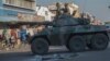 FILE: An army tank patrols on a street in Harare during protests by opposition party supporters Wednesday, Aug. 1, 2018. Hundreds of angry opposition supporters outside Zimbabwe's electoral commission were met by riot police firing tear gas as the country awaited the results of Monday's presidential election, the first after the fall of longtime leader Robert Mugabe. (AP Photo/Mujahid Safodien)