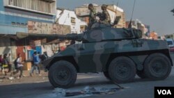 FILE: An army tank patrols on a street in Harare during protests by opposition party supporters Wednesday, Aug. 1, 2018. Hundreds of angry opposition supporters outside Zimbabwe's electoral commission were met by riot police firing tear gas as the country awaited the results of Monday's presidential election, the first after the fall of longtime leader Robert Mugabe. (AP Photo/Mujahid Safodien)