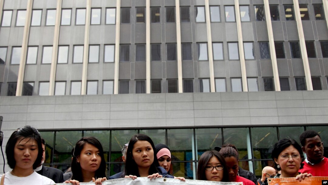 FILE - Supporters of immigration reform stand in front of U.S. Citizenship and Immigration Services in New York, June 25, 2012. 